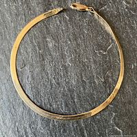 Full view of flat herringbone bracelet laid out in a circle