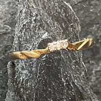 Front-facing view showing three-stone cluster