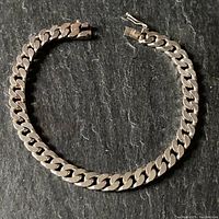 Sterling silver men's dog chain bracelet laid out flat showing full length and clasp.