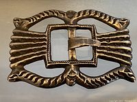 Full front view of the large sterling silver belt buckle with its ornate molded design.