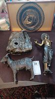 Lot contents showing bronze statue pieces, bronze goat figurine, bronze base, brass plate in case