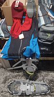 Lot contents including jacket, red scarf, grey mittens, cooler bag, snowshoes