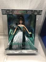 Front view of the boxed 2005 Holiday Barbie by Bob Mackie wearing green and silver gown with winter holiday theme.
