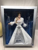 Front view of the Barbie Winter Fantasy 2003 doll in original box, showing the full outfit and decorative background.