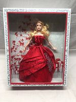 Front view of the Barbie doll in original box showing red satin gown, jewelry, and clear display window.
