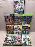 Photo showing all 10 Xbox 360 game cases arranged in a grid with visible titles and covers.