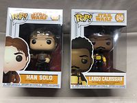 Lot of 2 Star Wars Funko Pop figures in original packaging, showing front of boxes with character names Han Solo and Lando Calrissian and respective numbers 238 and 240.