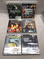 Photo showing all six PS3 game cases together on a surface.