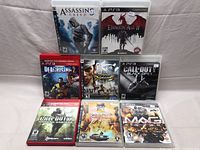 Front view of the 8 PS3 game cases arranged in two rows.