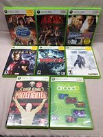 Front view of all 8 Xbox 360 game cases laid out in two rows showing clear cover art and titles.