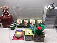 Overview of entire lot showing candles and holders in boxes and unboxed