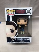 Front view of the boxed Eleven elevated Funko POP! figure showing the figure inside the clear window display and box art labeled 637