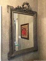 Full front view of mirror against patterned wallpaper