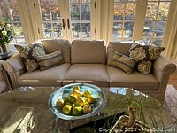 Full front view of sofa with throw pillows and coffee table
