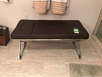 Front view showing full tufted cushion and chrome X-frame base