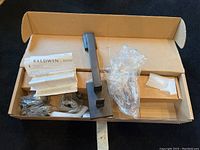 Overview of the Baldwin Reserve door handle set components in box including instructions, handle, and accessories.