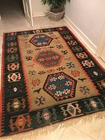 Full view of rug laid out on tile floor