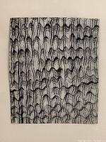 Close-up of abstract pen and ink artwork showing detailed pattern of curved black lines on paper.
