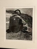 Close-up of the signed and numbered black and white etching depicting a seated man on a cliff showing detail of signature and numbering.