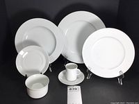 Group layout showing dinner plates, salad plates, coffee cups with saucers, soup bowls and demitasse cups with saucers on display.