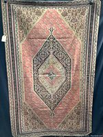 Full view of the vintage oriental rug showing overall design and wear.