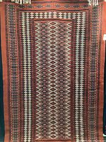 Full view of vintage Tunisian Kilim rug laid flat, showing overall geometric pattern and colors.