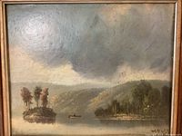 Framed oil on board painting showing overall landscape scene with water, islands, trees, mountains and signature.