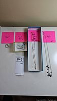 Full lot photo with all four items: one ring and three necklaces, each necklace length labeled as 16", 18", and 20"
