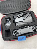Photo showing foldable air drone and remote control inside custom foam insert of case