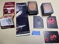 Overview photo showing two stacks of Magic cards, guides, and counters.
