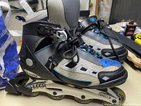 Pair of Hyper inline roller skates showing side view of left skate with gray, black and blue colors.