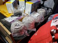 Five or more coiled rolls of white Cat 5 Ethernet cable wrapped in plastic, shown on tabletop with other tools.