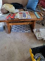 Wide angle of custom wooden table with cribbage and checker boards on top showing game detail and surrounding items