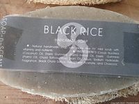 Close-up of Black Rice label on a single soap bar showing ingredients and branding
