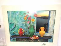 Photo showing one of the colorful wall decor prints with vases and flowers on a tabletop.