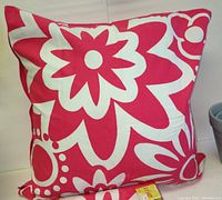 Photo showing a fuchsia and white floral patterned outdoor cushion and matching cushion covers.
