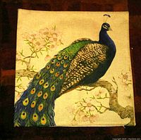 Square cushion cover featuring a peacock sitting on a branch with floral background in soft colors