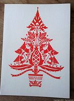 Front of card shows traditional Hungarian folk art Christmas tree design in bright red ink on white card stock.