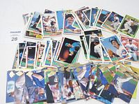Photo showing numerous baseball cards spread out, showcasing varied players and teams.