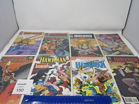Photo showing all eight Hawkman comic books laid out on a surface to display covers