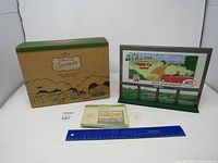Photo shows the collectible Hallmark Kiddie Car Corner sign standing beside its original green and brown box and a ruler for size reference.