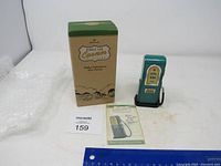 Photo of Hallmark Pedal Petroleum Gas Pump model with original box and leaflet, placed near a ruler for scale.