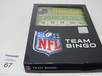 NFL Team Bingo game box with Pittsburgh Steelers theme visible through window.