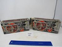 Two train-themed boxes featuring train wheel and mechanical graphics, containing Avon leather after shave bottles.