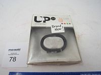 Photo of the UP Jawbone wrist fitness tracker in original packaging with label 'Brand New!' on the box.