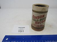 Front view of the cylindrical container showing the 'Edison Gold Moulded Record' label with measuring scale for size reference.