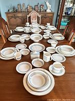 Full set arranged on dining table showing all pieces including place settings and serving pieces.