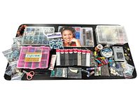 Overview photo of the jewelry making craft lot showing beads, wires, tools, and storage boxes arranged on a dark surface.