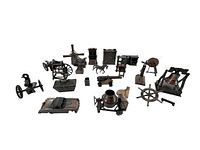 Lot of miniature brass pencil sharpeners including Liberty Bell, cannons, windmill, spinning wheel, cement truck, vintage car, western saddle, horse-drawn carriage, and more items arranged in a group.
