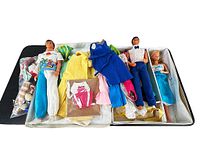 Three dolls and assorted clothing neatly arranged inside a soft-sided carrying case.